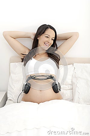 Pregnant woman - playing music to baby