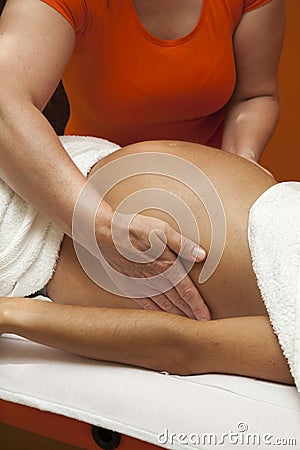Pregnant woman receiving relaxing massage