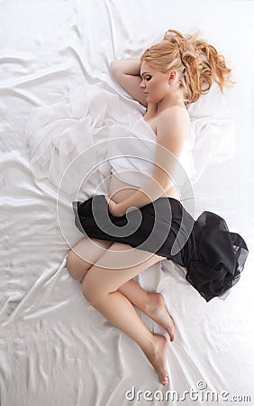 Pregnant woman sleeping under black and white silk