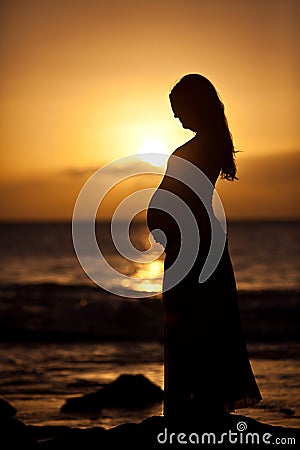 Pregnant woman at sunset