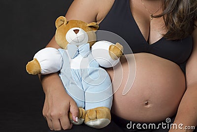 Pregnant woman with teddy bear