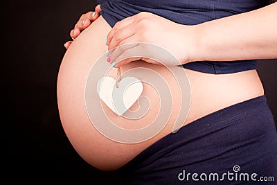 Pregnant women with heart on her belly