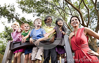 Preschool children on playground with teacher