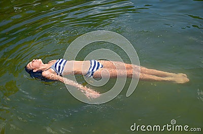 Preteen Girl Floating in Water