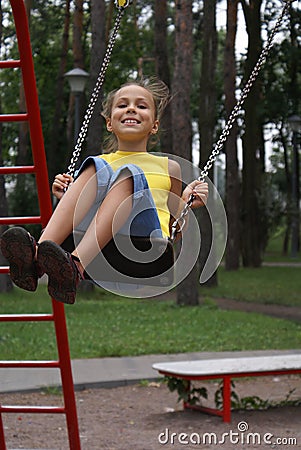 Preteen girl on swing set
