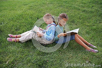 Preteen school girls reading books