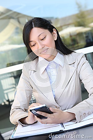 Pretty Asian Woman Texting at Work