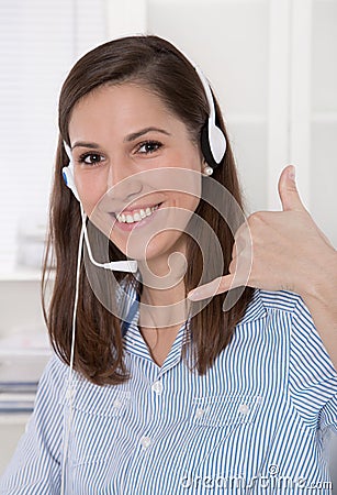 Pretty brunette businesswoman wearing blue blouse with headset