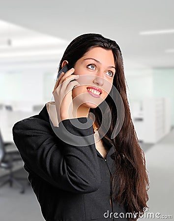 Pretty business woman on cell phone at office