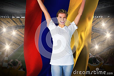 Pretty football fan in white cheering holding colombia flag
