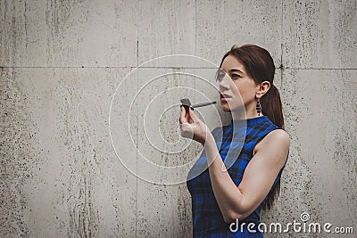 Pretty girl smoking vintage pipe