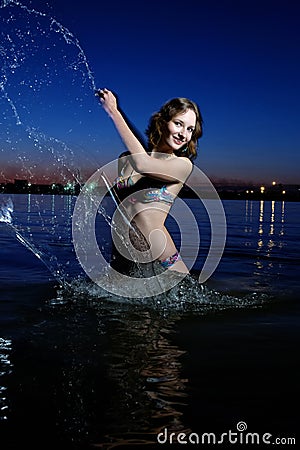 Pretty sexy woman in bikini splash out the water