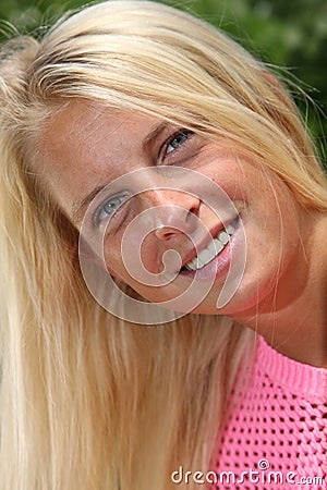 Pretty sun-tanned blond girl in natural light