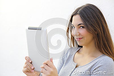 Pretty woman holding a tablet and looking at camera