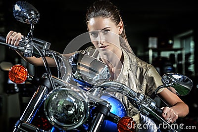 Pretty woman on motorcycle at night