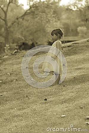 Pretty 3 1/2 year old Asian-Caucasian girl standing on grass