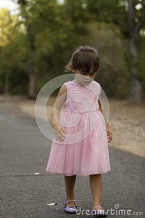 Pretty 3 1/2 year old Asian-Caucasian girl standing on grass