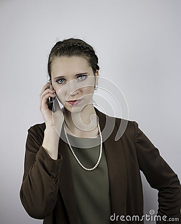 Pretty young businesswoman using cell phone