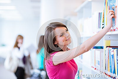 Pretty young college student in a library