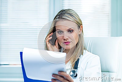 Pretty Young Female Doctor Is Consulting Medical Results