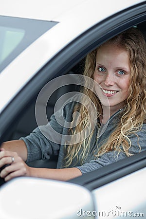 Pretty young woman driving her car