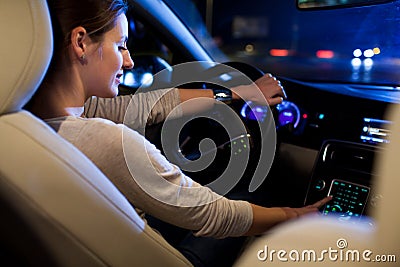 Pretty, young woman driving her modern car