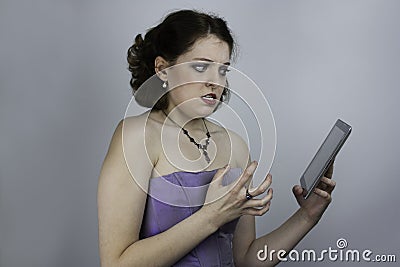 Pretty young woman frustrated by tablet