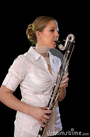 Pretty young woman playing bass clarinet