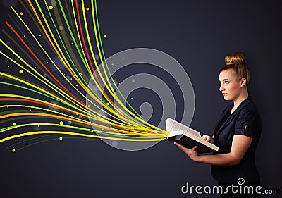 Pretty young woman reading a book while colorful lines are comin