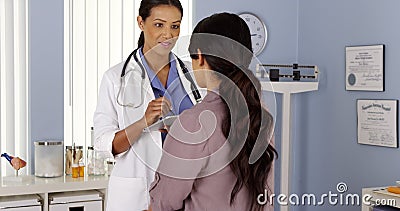 Primary Care Physician talking to female patient in Exam room