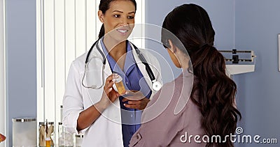 Primary Care Physician talking to female patient in Exam room