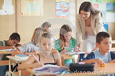 Primary School Teacher Helping Students