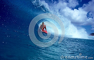 Pro Bodyboarder Alex Kinimaka in a Blue Tube Wave