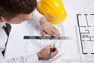Professional architect drawing construction plan.