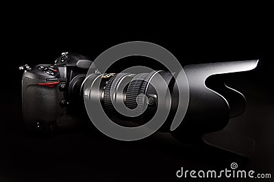 Professional digital photo camera against black background