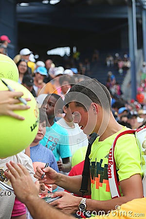 Professional tennis player Miols Raonic signing autographs after third round match at US Open 2014