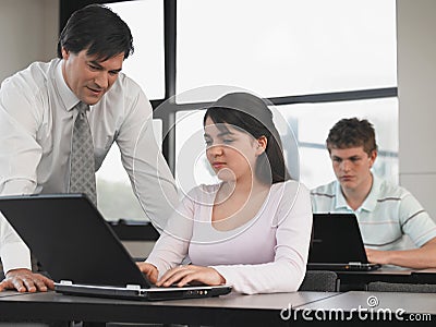 Professor Teaching Students In Computer Class