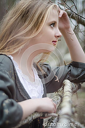 Profile picture of blond girl touching her head