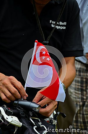 Protester plants flag on bicycle at Singapore rally