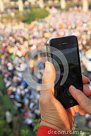 A protester uses a smartphone to capture an anti-government corruption protest