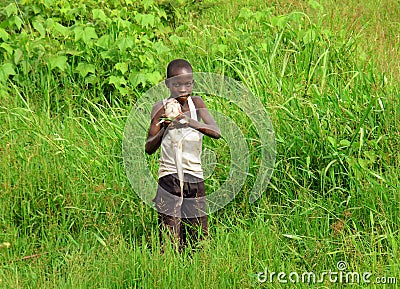 Proud African boy catches fish to feed family