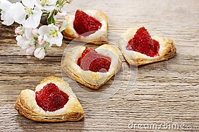 Puff pastry cookies in heart shape filled with strawberries