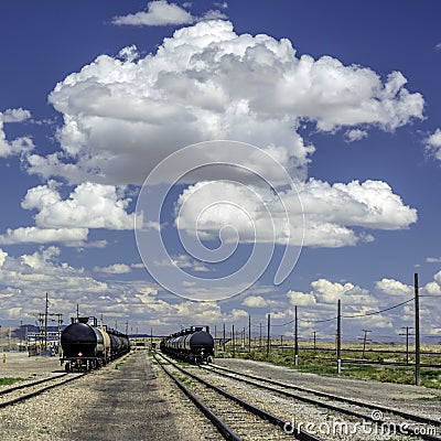 Puffy clouds over train cars