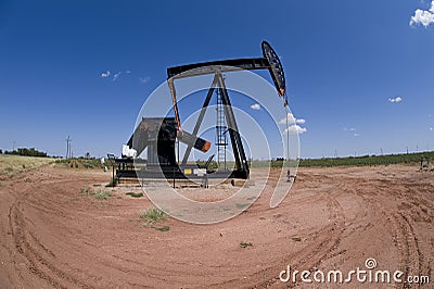 Pumpjack over oil well