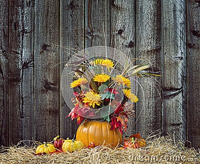 And Melons On Hay Against Rustic Background Pumpkin Flower Arrangement Against Wood Background Stock