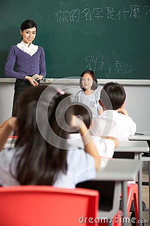 Pupil And Teacher Standing In A Chinese School
