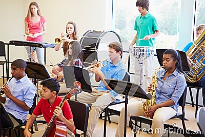 Pupils Playing Musical Instruments In School Orchestra