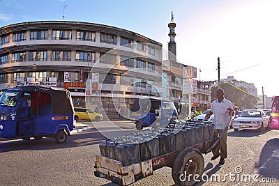 Pushing a cart. Kenya.