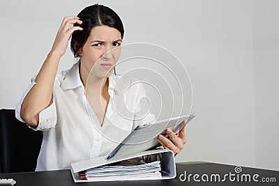 Puzzled woman scratching her head