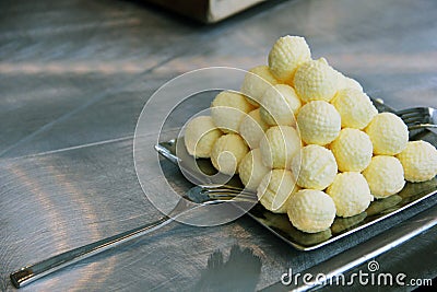 Pyramid of Butter Balls on stainless steel plate